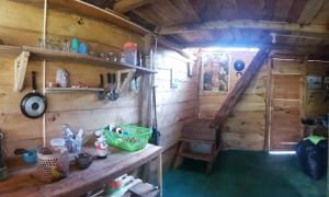an inside view of a wooden cabin with a table and shelves at Gocta Dulce Hogar in Cocachimba