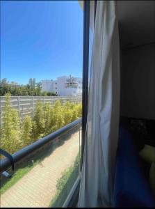 a window in a room with a view of a building at Cosy appartement à Ain Diab beach in Casablanca