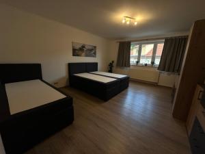 a living room with two beds and a couch at Ferienwohnung an der Thyrahöhe in Stolberg