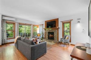 a living room with a couch and a fireplace at Les Falaises Tremblant - Ski Inout Condo W2bdrs in Mont-Tremblant