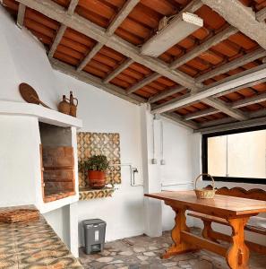 Habitación con mesa de madera y ventana. en Nina's Stay Hostel en Charneca
