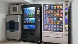 a soda vending machine next to a drink cooler at Motel 6-Nashua, NH - South in Nashua
