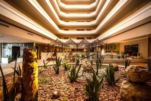 a lobby with a large lobby with rocks and plants at Garden Court Kimberley in Kimberley