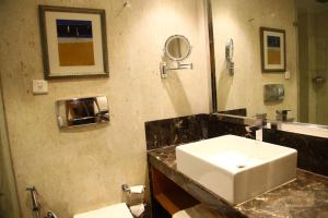 a bathroom with a sink and a mirror at The Place Gurugram, a member of Radisson Individuals in Gurgaon