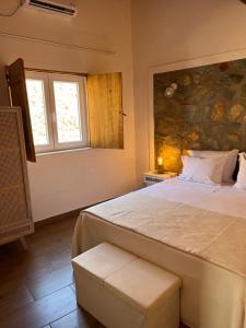 a bedroom with a large bed and a window at Casa do Forte Elvas in Elvas