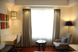 a room with a window with a chair and a desk at The Place Gurugram, a member of Radisson Individuals in Gurgaon