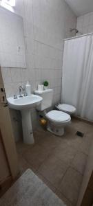a bathroom with a toilet and a sink at Umbrella 2 in La Rioja +26 photos