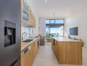 a kitchen with a sink and a counter top at Cabarita Beachside - Hosted by Holiday Management in Cabarita Beach