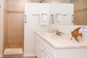 a bathroom with a sink and a shower at Beach Retreat - A treat to be had by all! in Long Beach