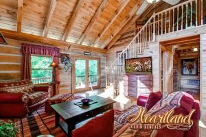 a log cabin living room with a wooden ceiling at Halfway To Heaven in Sevierville