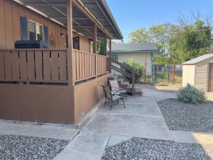 a porch of a house with a deck and chairs at All season vacation home! in Cottonwood