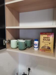 a kitchen shelf with bowls and a box of food at Apartment Lora in Burgas