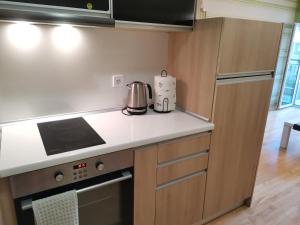 a kitchen with a stove and a counter top at Apartment Lora in Burgas