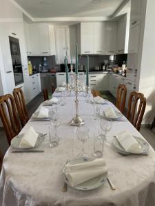 a dining room table with a white table cloth and glasses at Casa da Celeste in Vale do Pereiro