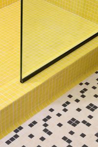 a yellow tiled floor with a black and white floor at YOWIE Hotel in Philadelphia