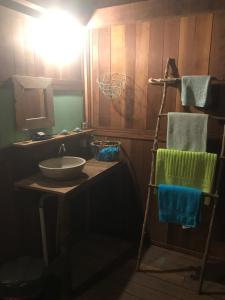 a bathroom with a sink and a mirror at Casa tartaruga in Castelhanos +21 photos