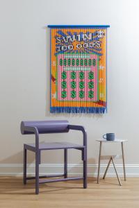 a table and bench in a room with a painting at YOWIE Hotel in Philadelphia