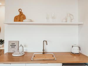 a kitchen with a sink and a counter top at Harrington Guest Suite in Harrington +15 photos