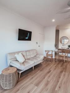 a living room with a couch and a table at Harrington Guest Suite in Harrington