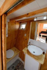 a small bathroom with a sink and a toilet at Namakai.tinyhouse, minimalism in a magic place in Los Árboles