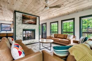 a living room with couches and a fireplace at Whispering Pines - Indoor Pool, Hot Tub, Fire Pit in Sevierville