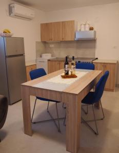 a kitchen with a wooden table with bottles of wine on it at Apartment Nadalina in Kraljevica