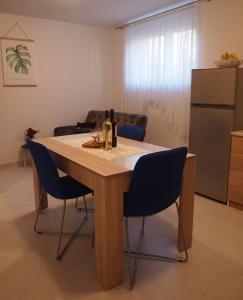a kitchen with a table with two bottles of wine at Apartment Nadalina in Kraljevica