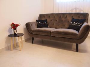 a brown couch sitting in a living room with a table at Apartment Nadalina in Kraljevica