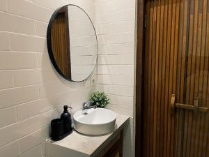 a bathroom with a sink and a mirror at Griya tropical in Ubud +12 photos