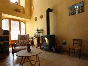 a living room with a wood stove in a room at Gîte Le Brignon, 3 pièces, 4 personnes - FR-1-582-177 in Le Brignon