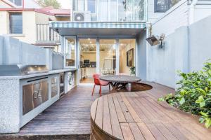 a wooden deck with a table and a kitchen at Surry Hills Terrace in Sydney