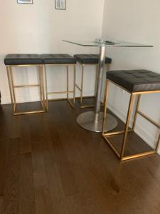 three bar stools with a glass table and a table andoolsuggest at Beautiful 1Bd Entertainment disrtrict. in Toronto