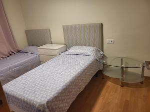 a room with two beds and a glass table at holiday hogar altea in Altea