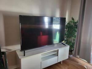 a flat screen tv sitting on a white entertainment center at holiday hogar altea in Altea