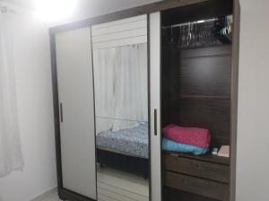 um guarda-roupa com um espelho num quarto em Casa da Bia apto 01 - apto inteiro em Vila Velha