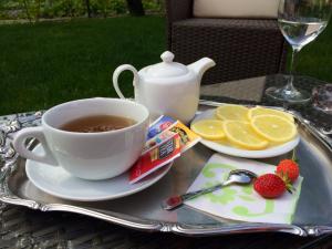 a cup of tea and strawberries and oranges on a tray at Agriturismo Ca' La Pergola in Verona
