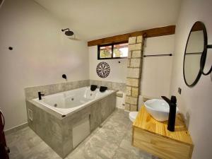 a bathroom with a large tub and a sink at Luxury Villa In Provenza in Medellín
