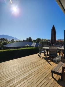 a wooden deck with a picnic table and an umbrella at Mountainview in Kaikoura