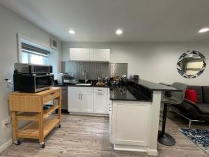 a kitchen with white cabinets and a counter top at Sonsak - Unit 5 in Charlottesville