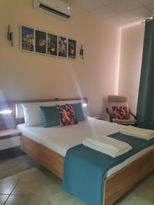 a bedroom with a large bed with a blue blanket at Casa da Vera in Faro