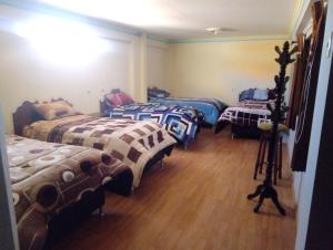 מיטה או מיטות בחדר ב-Wayky's Club and Hostal