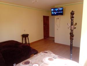 a bedroom with a bed and a tv on the wall at Wayky's Club and Hostal in Copacabana