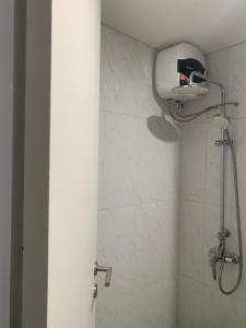 a bathroom with a shower with a shower head at Apartermen Skylouge Makassar in Manda