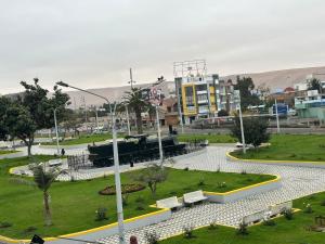 a park with benches and buildings in a city at HOSPEDAJE CALLAO in Tacna