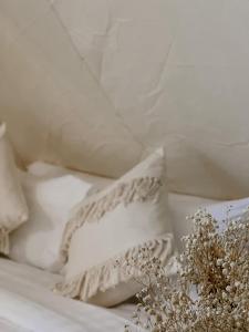a pile of white pillows on a bed at Greenheart garden View Camp phuket in Kata Beach
