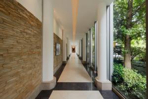 a hallway of a building with a stone wall at DoubleTree by Hilton Shanghai Pudong - Present welcome cookie in Shanghai