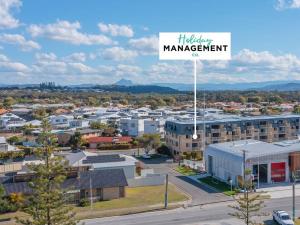 an aerial view of a city with a management sign at Kingscliff Beachfront Abode - Hosted by Holiday Management in Kingscliff