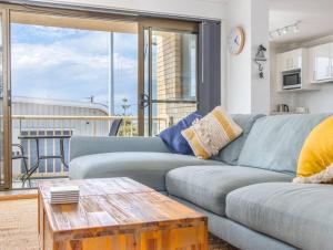 a living room with a couch and a table at Kingscliff Beachfront Abode - Hosted by Holiday Management in Kingscliff