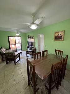 a living room with a dining room table and chairs at Guarujá enseada, apto a 150m da praia. in Guarujá