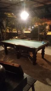 a pool table in a room with a light at Bamboo Bungalow - Thong Nai Pan Yai in Thong Nai Pan Yai